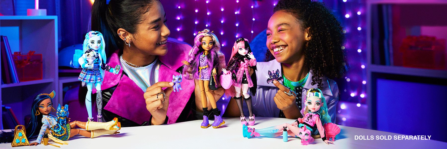 Kids playing with Monster High dolls in a neon-lit room